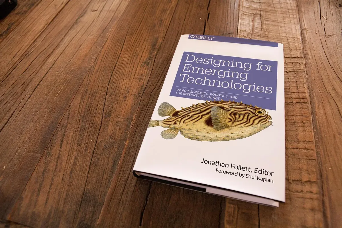 Designing for Emerging Technologies, edited by Jonathan Follett, on a wooden table